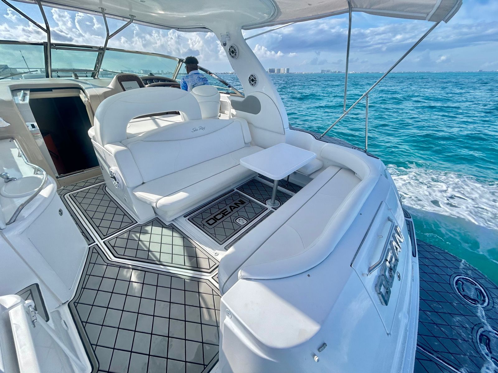 Luxury yacht cockpit deck Sea Ray Cancun hotel zone skyline private charter